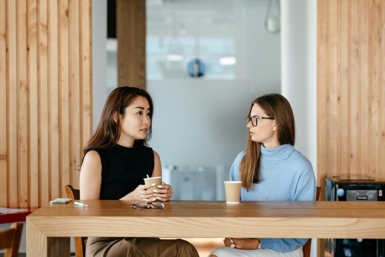 https://www.pexels.com/photo/diverse-women-talking-during-coffee-break-at-table-6457519/